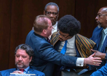 Tennessee Rep. Justin J. Pearson (right) is restrained as he confronts Rep. Andrew Farmer (left) during a heated House subcommittee hearing on gun laws