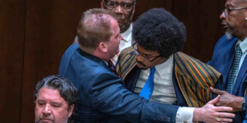 Tennessee Rep. Justin J. Pearson (right) is restrained as he confronts Rep. Andrew Farmer (left) during a heated House subcommittee hearing on gun laws
