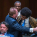 Tennessee Rep. Justin J. Pearson (right) is restrained as he confronts Rep. Andrew Farmer (left) during a heated House subcommittee hearing on gun laws